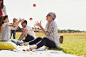 Grandmother and grandson juggling apples on picnic blanket in sunny field by Caia Images on 500px