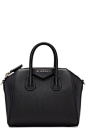 Givenchy - Black Mini Antigona Bag : Structured 'sugar' goatskin duffle bag in black. Twin rolled carry handles at top. Adjustable and detachable shoulder strap with hook fastening. Logo plaque at face. Zip closure. Zippered pocket, patch pockets, and lea
