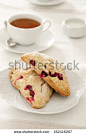 Closeup of freshly baked cranberry scones and tea. - stock photo