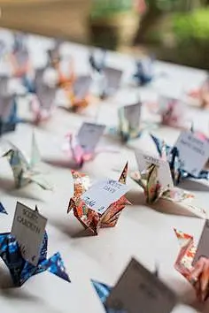 pretty paper crane wedding escort cards at reception