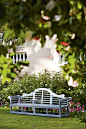 A classical bench on the main terrace is softened with a background of Iceberg roses: 