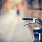 Handlebar of an Old Bike Resting in the Narow Street (vintage color toned image)