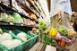 Man carrying full shopping basket in grocery store by Caia Images on 500px