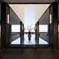 This may contain: an empty room with wooden floors and large windows overlooking the ocean is shown in this image
