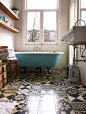 Gorgeous bathroom. In love with the colour of the tub and the patterns on the floor tiles. Great, bright space.