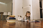 Sweet girl reading books on floor Free Photo