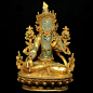 A beautiful 8 in. (20.3 cm) Nepalese gold gild bronze of the White Tara. This incredible statue showcases the White Tara's body hand carved in quartz crystal. The White Tara's jewelry has been inlaid with lapis, turquoise, and red coral.