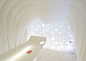 Kotaro Horiuchi creates a Paper Cave inside his architecture studio : Japanese architect Kotaro Horiuchi has created a white cave-like space in his office by hanging sheets of glass fibre paper from the ceiling.