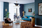 Eclectic medium tone wood floor and brown floor living room photo in New York with blue walls