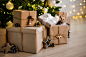 close-up-beige-gift-boxes-near-decorated-christmas-tree-home