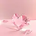 Light pink background, clean background, heart-shaped crystal transparent body, crystal body with angles, crystal is smooth, two ribbons on the ground, product rendering , 3D ar 16:9