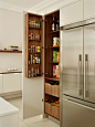 Example of a large trendy kitchen pantry design in London with flat-panel cabinets, white cabinets and stainless steel appliances