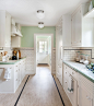 Example of a classic galley kitchen design in Sacramento with white cabinets, tile countertops, white backsplash, subway tile backsplash, paneled appliances and shaker cabinets