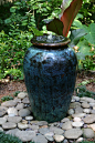 Pondless water feature - Pot w/ mexican pebbles.    Google Image Result for http://www.ericaglasener.com/wp-content/uploads/2011/08/Water-garden-in-large-glazed-pot-with-view-of-top-1.jpg