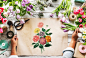 Florist showing empty design space paper on wooden table with fresh flowers decorate