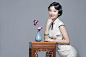 Young beautiful woman in traditional cheongsam with orchid
