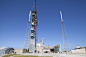 2015-3199 : A crane lifts the roof of the Crew Access Tower into place at Space Launch Complex-41. As with the previous elements, the roof was built at a construction yard four miles south of the launch pad. The Crew Access Tower will stand 200 feet tall 