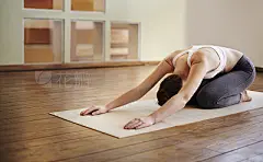 Drop and give me zenShot of a young woman practicing yoga at home
