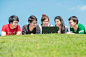 Group of young student using laptop together in the park by Prasit Rodphan on 500px