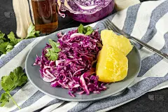 1个红卷心菜沙拉盘，里面有番茄，青菜，煮土豆，合上，蔬菜维他命沙拉