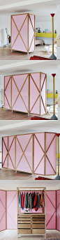 This pink wardrobe becomes a room divider! A pink wardrobe and room divider! The wardrobe itself has a white metal frame with closet rod and reclaimed wood drawers.