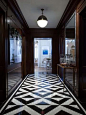 Dramatic black and white geometric floor makes this a eye catching hallway: 