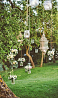 Add an ethereal touch to proceedings with flower-filled jars hanging off tree branches.  Photo | Les Amis