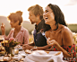 Smiling people at dinner party outside
