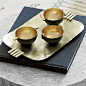eastern influence.  Sculptural brass tray by designer Neelima Rao serves a sleek fusion of eastern artistry.  To Rao, the minimal beauty of Japanese kettles, tea ceremonies and sake cups "have always touched a chord, and I wondered if there was an In