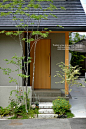 Japanese small front garden, natural wood and plaster