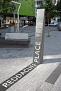 Example of Signage incorporated into landscape using large type  - Reddacliff Place Memorial, Brisbane