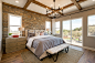 Example of a transitional guest medium tone wood floor, brown floor, coffered ceiling and exposed beam bedroom design in San Luis Obispo with beige walls