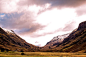 Grass Field Between Two Mountains