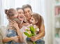 stock-photo-happy-mother-s-day-two-children-daughters-with-dad-congratulate-mom-and-give-her-flowers-tulips-613434878