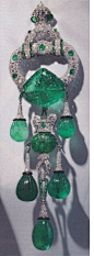 Cartier. Shoulder brooch owned by Majorie Merriweather Post. Eight inches long, set in platinum. 250 carats of carved Indian emeralds from the 17th Mughal period. Set by Cartier New York, 1928