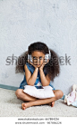 cute African girl at home, listening to music in big white headphones