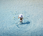 Pacific Islander woman walking with fish in ocean