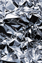 This shows texture because its as if you could reach out and feel the texture of the aluminum foil