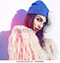 Young beautiful woman winter portrait. Blue hat. Sunglasses. Hipster lifestyle. 