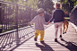 Boy and Girl Walking on Bridge during Daytime