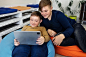 Two young boys using a tablet and working together