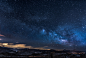 mountains with trees under white star at night