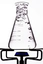Untitled - Beaker with boiling water on gas burner with white background