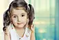 Little girl  looking at camera. Small child closeup on  background.