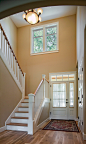 This is an example of a medium sized traditional foyer in Portland with beige walls, medium hardwood flooring, a single front door and a white front door.