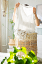 Caucasian woman sorting dirty laundry basket laundry at home