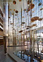 Marking the entrance to the residential lobby, Jaume Plensas installation of stainless-steel rods and gold-plated cymbals represents the 196 countries in the world. Photography by Nick Merrick/Hedrich Blessing.: Marking the entrance to the residential lob