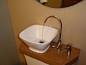 Add a toilet-top sink and re-use your gray water to flush the toilet. This tutorial shows you how to do it for much cheaper than the retail product that's out there.: 