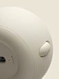 This may contain: a close up of a white speaker with buttons on the front and side of it