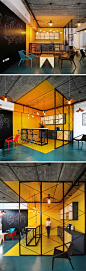 Interior Design Idea - Use Color To Define An Area // In this kitchen within an office, bright yellow walls, floor and ceiling clearly defines the area, while the interior designers have used a teal floor color to outline a casual seating area that surrou